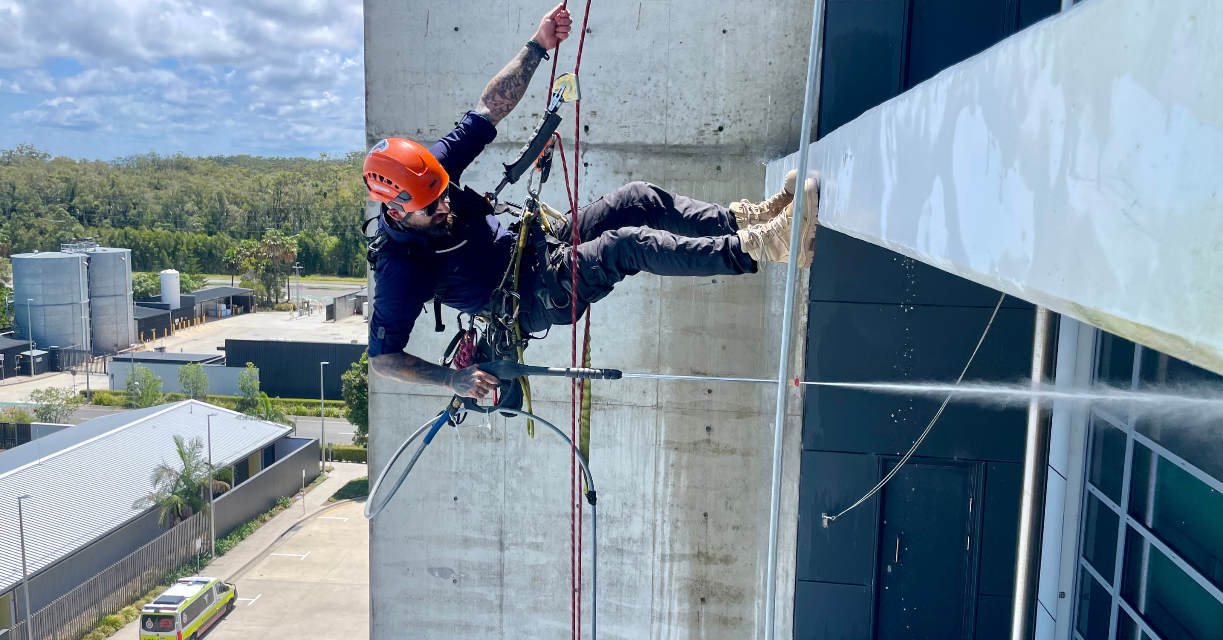 Rope climber scaling concrete industrial structure