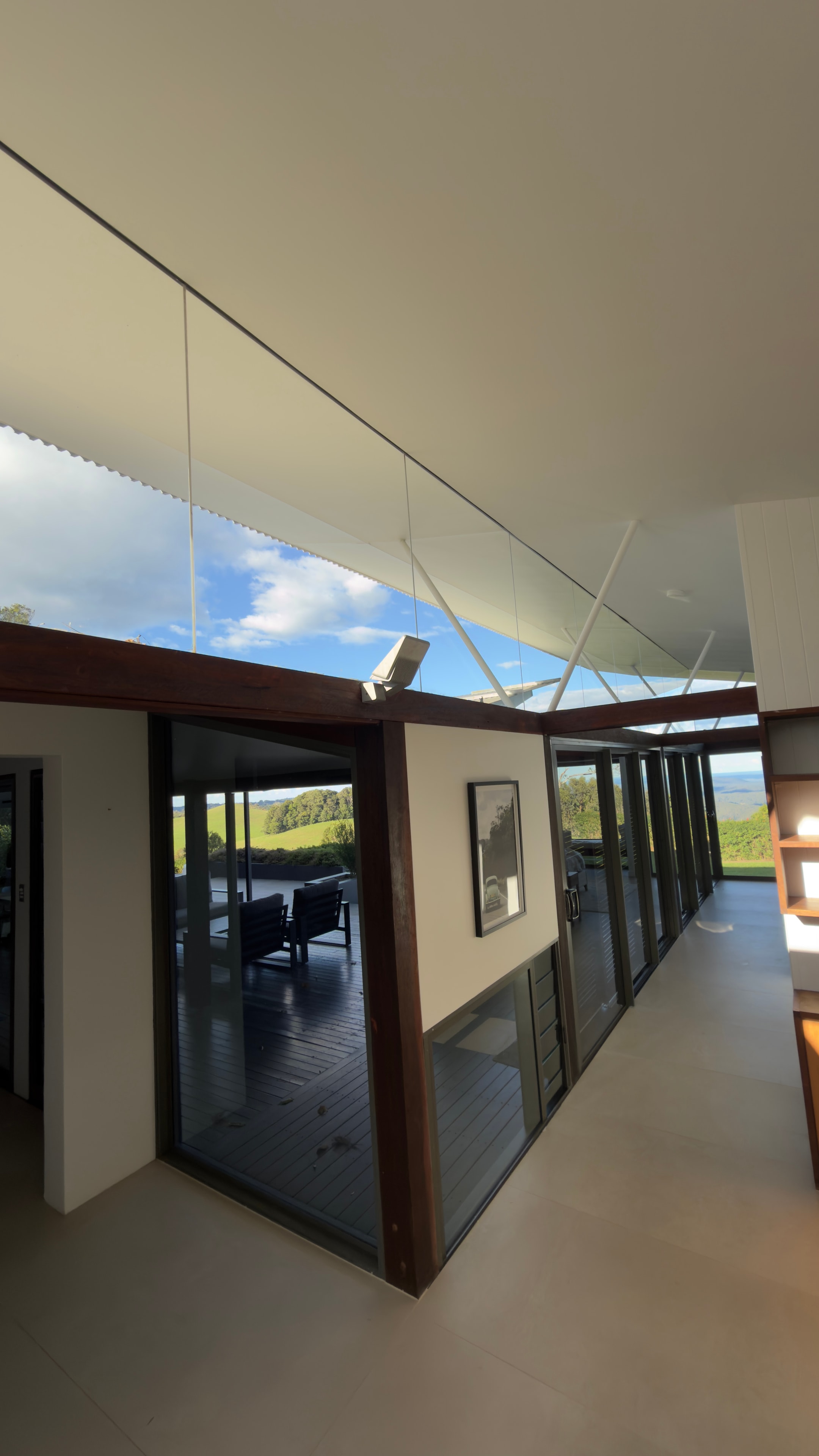 Modern hallway with glass doors countryside view