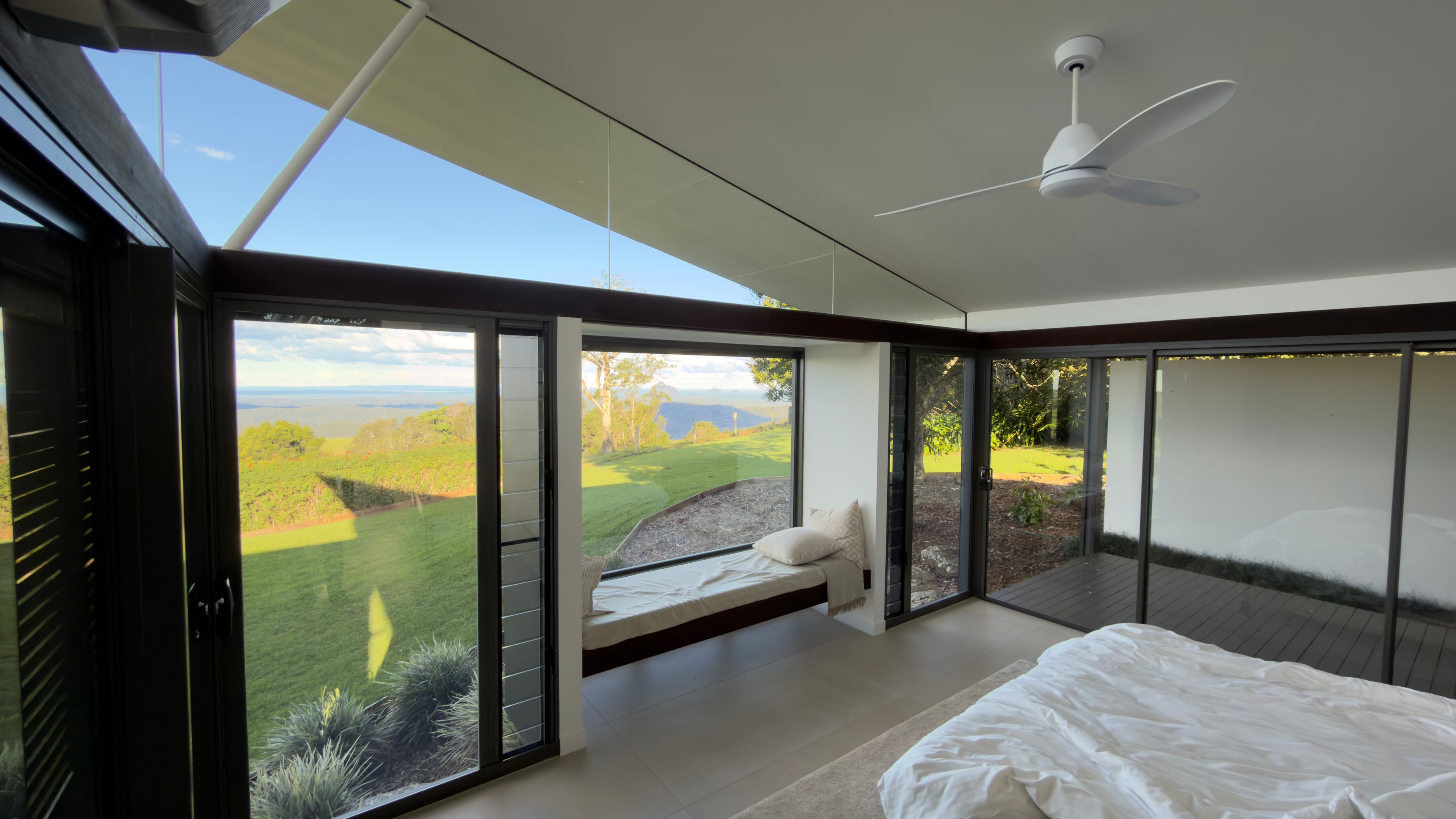 Modern bedroom with ocean view windows