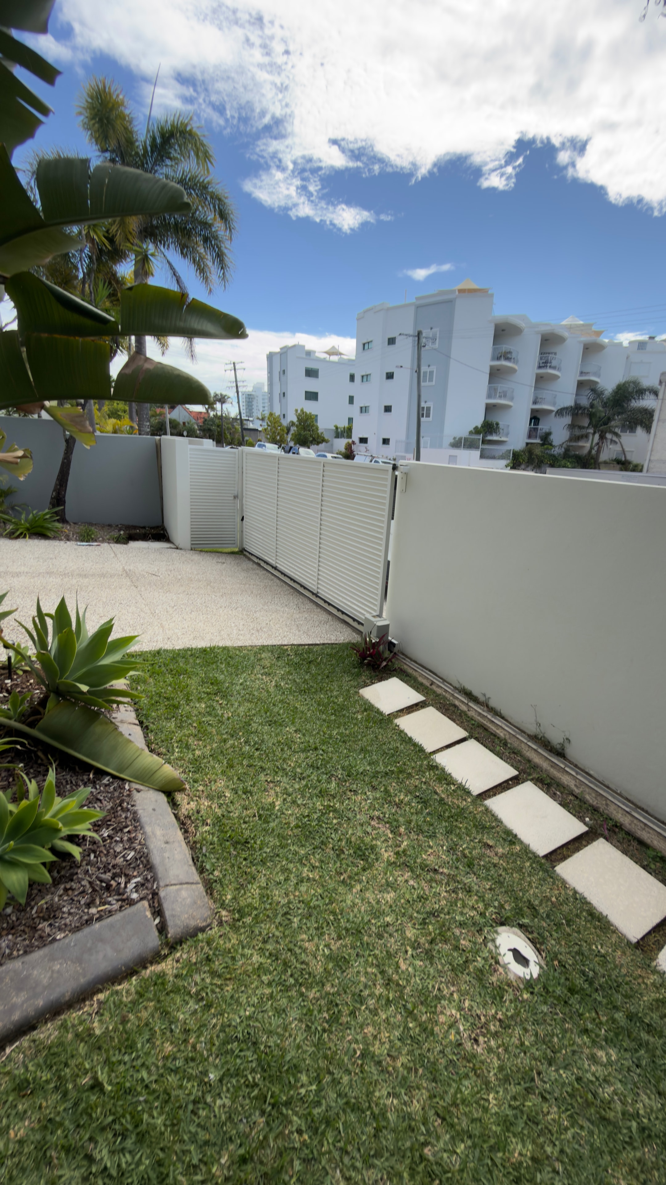 Modern residential courtyard with white apartments